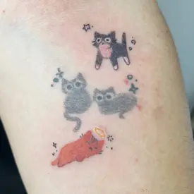 a colorful tattoo of two small cats